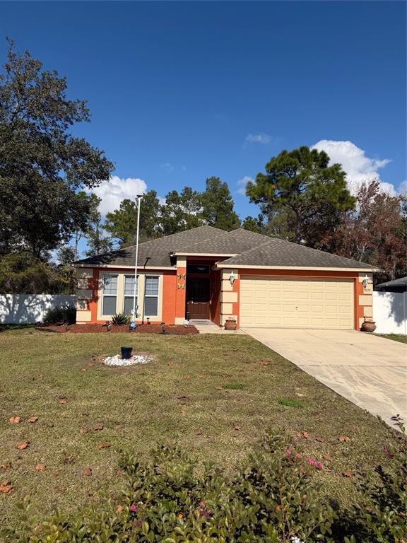 a front view of house with yard and trees in the background