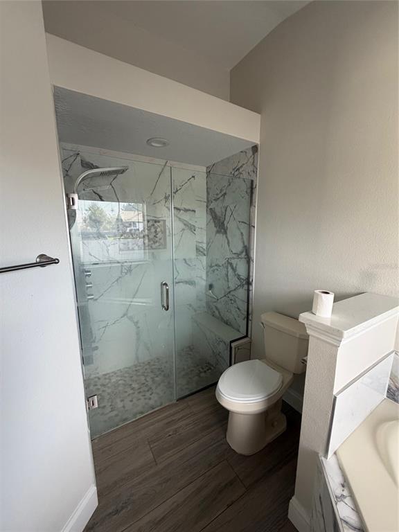 3020 Norlina Street Deltona, FL 32738 - Photo 16 of 30 a white toilet sitting next to a bathroom sink and a mirror