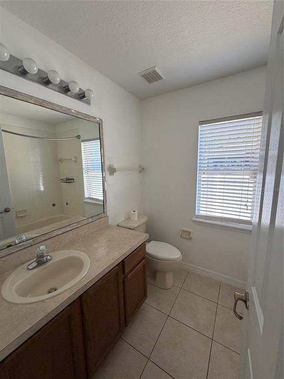 3020 Norlina Street Deltona, FL 32738 - Photo 20 of 30 a bathroom with a sink toilet and mirror