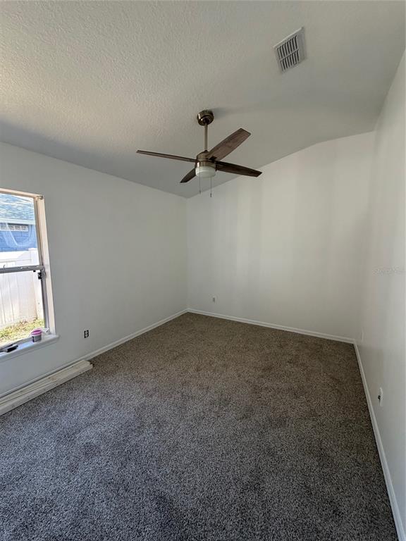 3020 Norlina Street Deltona, FL 32738 - Photo 25 of 30 an empty room with a window and a ceiling fan