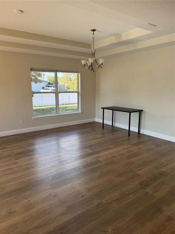 3020 Norlina Street Deltona, FL 32738 - Photo 7 of 30 a view of a livingroom with wooden floor a ceiling fan and window