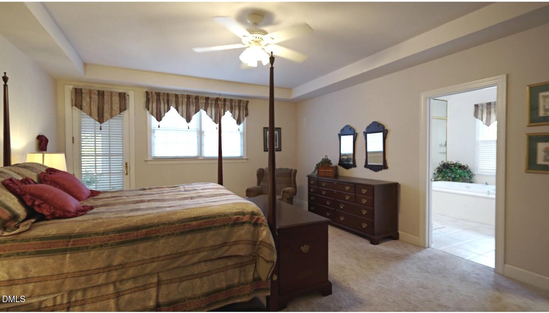 220 Jordan Narron Road Selma, NC 27576 - Photo 37 of 87 a bedroom with a bed and a chandelier