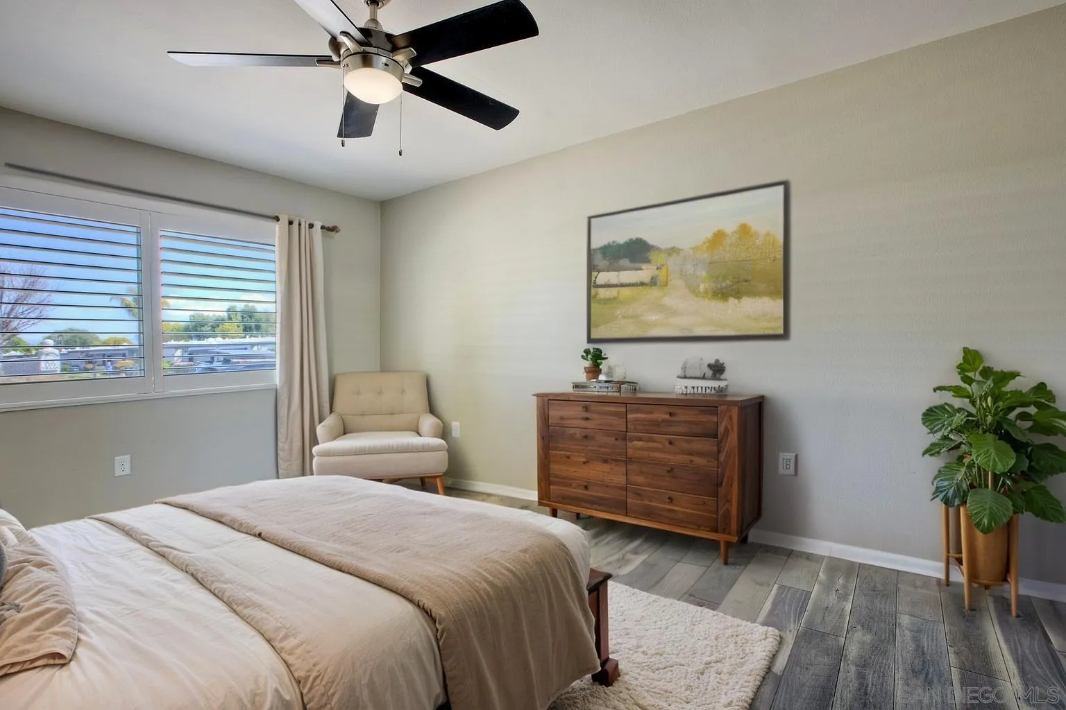 26055 Cherry Hills Boulevard Menifee, CA 92586 - Photo 11 of 31 a bedroom with a bed and a potted plant
