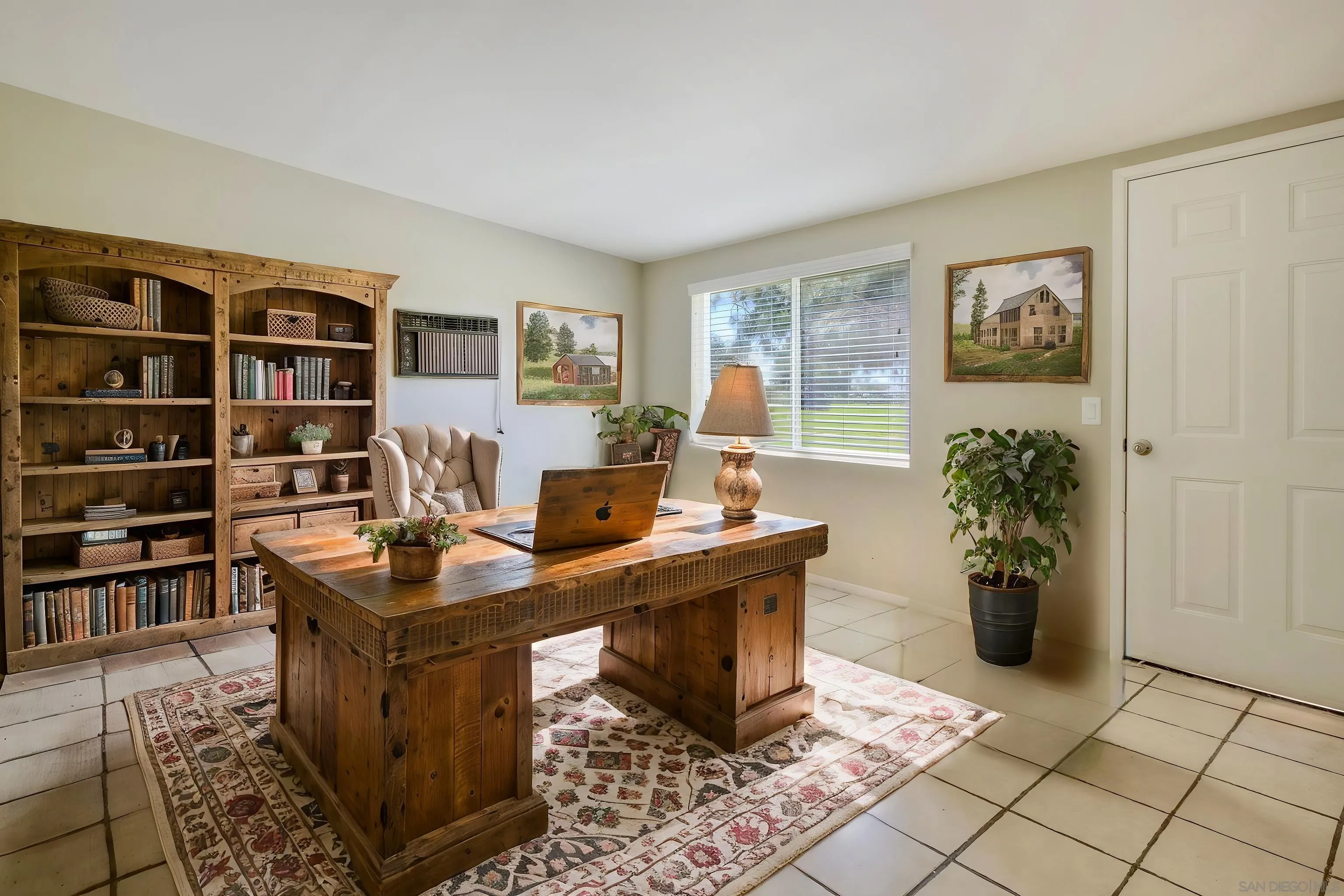 26055 Cherry Hills Boulevard Menifee, CA 92586 - Photo 12 of 31 a view of a workspace with furniture and a bookshelf