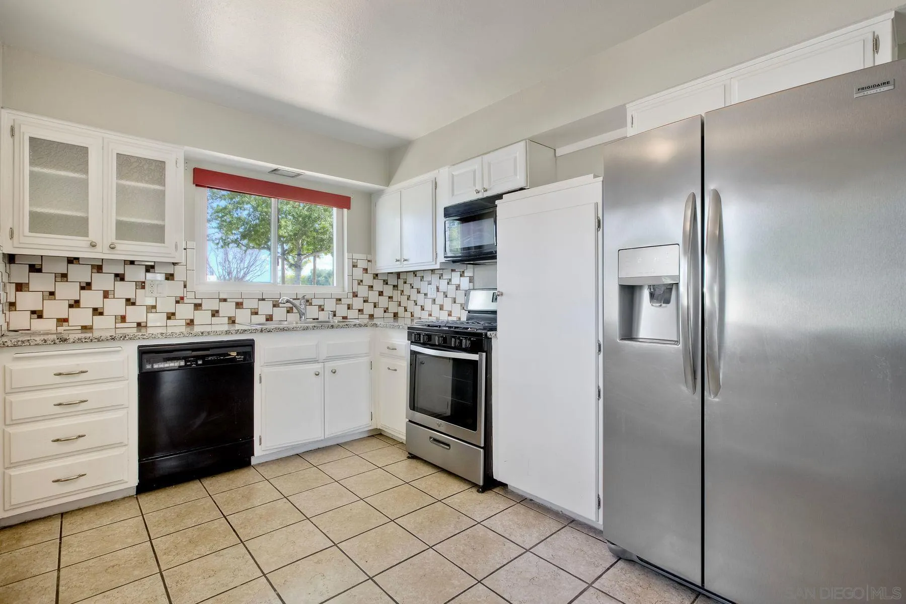 26055 Cherry Hills Boulevard Menifee, CA 92586 - Photo 15 of 31 a kitchen with granite countertop white cabinets and stainless steel appliances