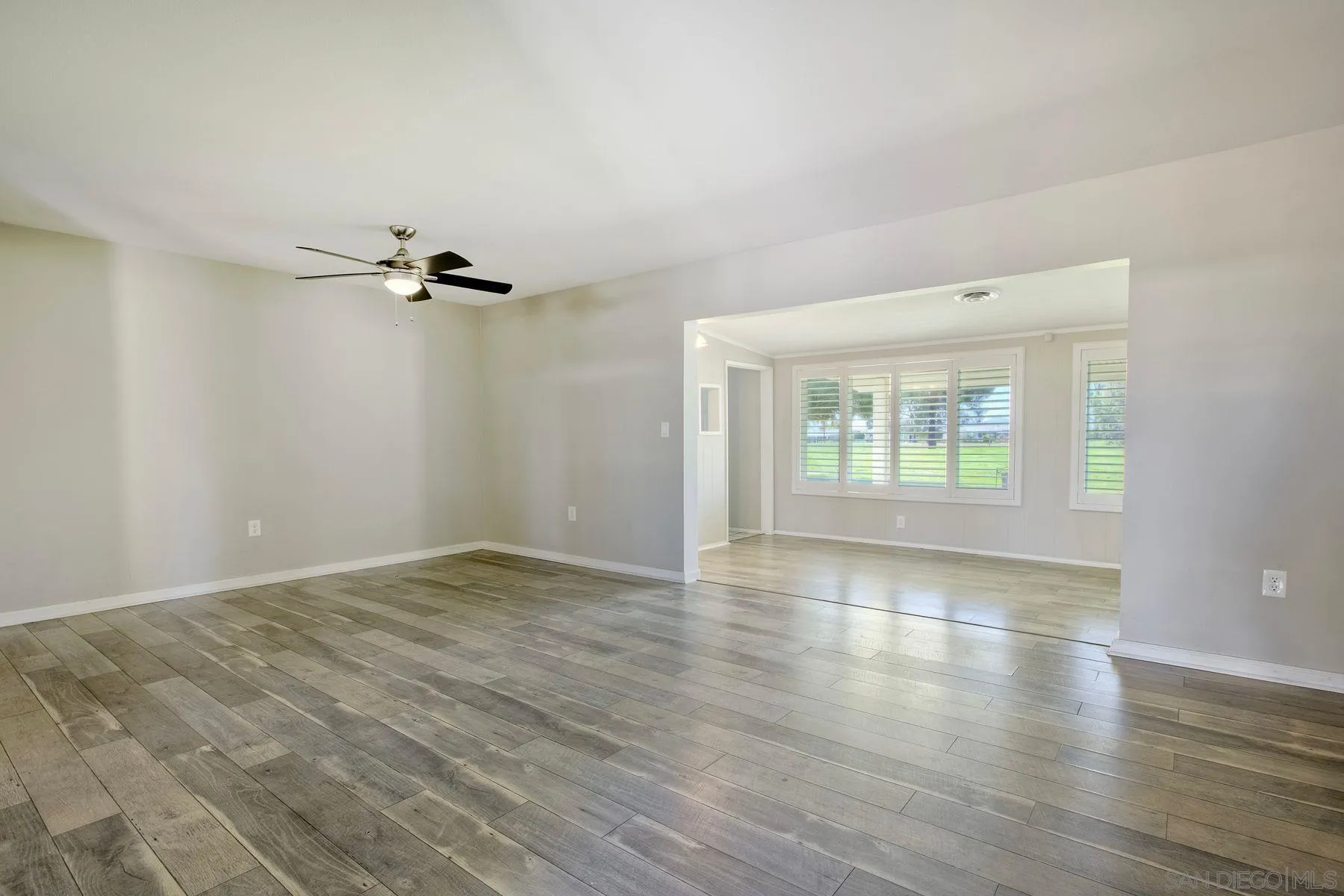 26055 Cherry Hills Boulevard Menifee, CA 92586 - Photo 17 of 31 wooden floor in an empty room with a window