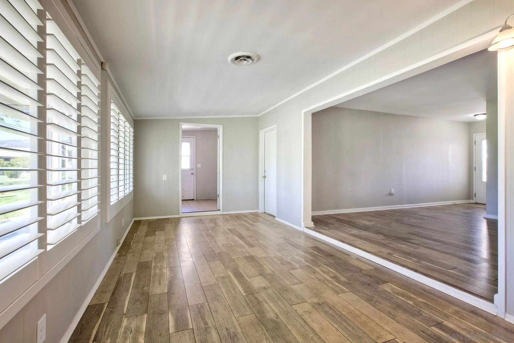 26055 Cherry Hills Boulevard Menifee, CA 92586 - Photo 18 of 31 a view of an empty room and window and wooden floor