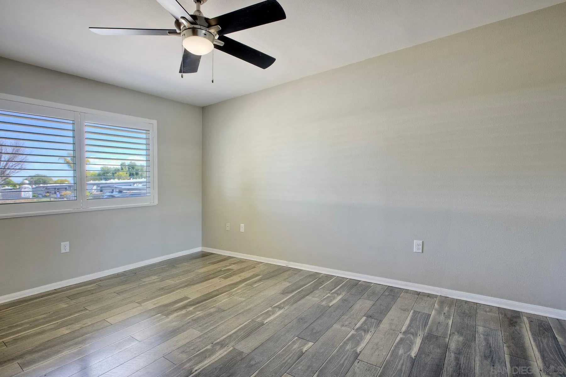 26055 Cherry Hills Boulevard Menifee, CA 92586 - Photo 20 of 31 wooden floor in an empty room with a window