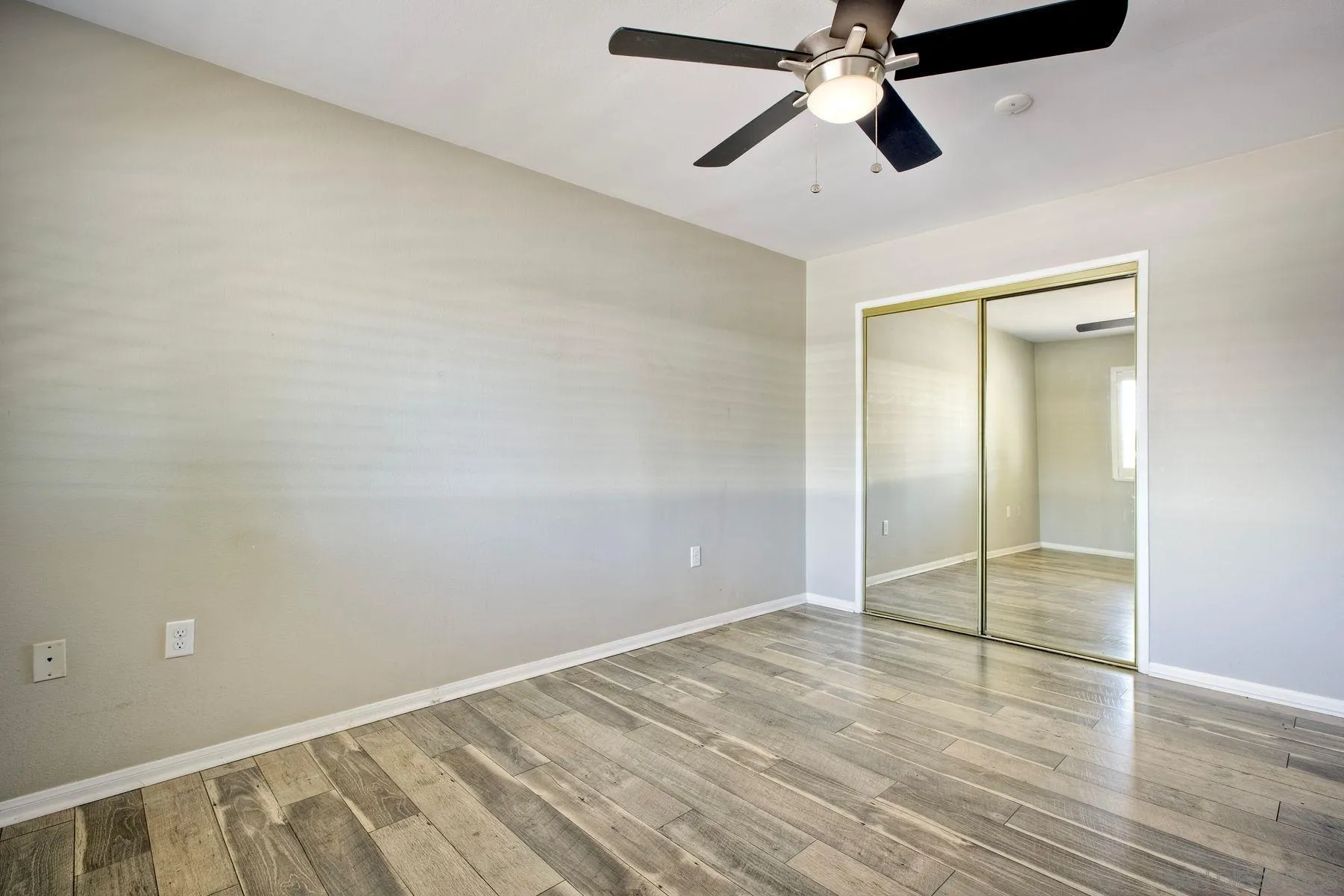 26055 Cherry Hills Boulevard Menifee, CA 92586 - Photo 21 of 31 an empty room with closet and a chandelier fan