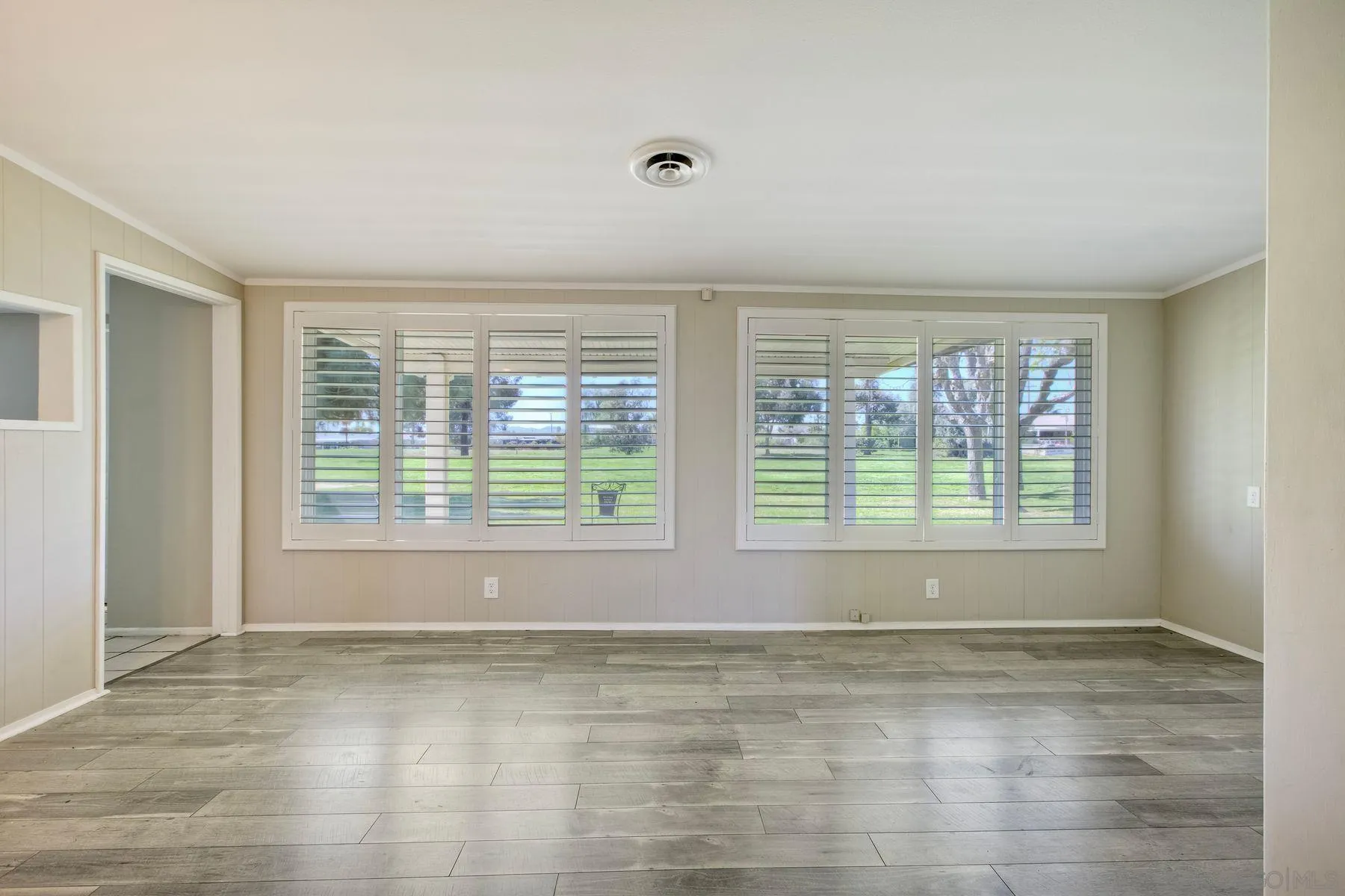 26055 Cherry Hills Boulevard Menifee, CA 92586 - Photo 24 of 31 a view of empty room with wooden floor and fan