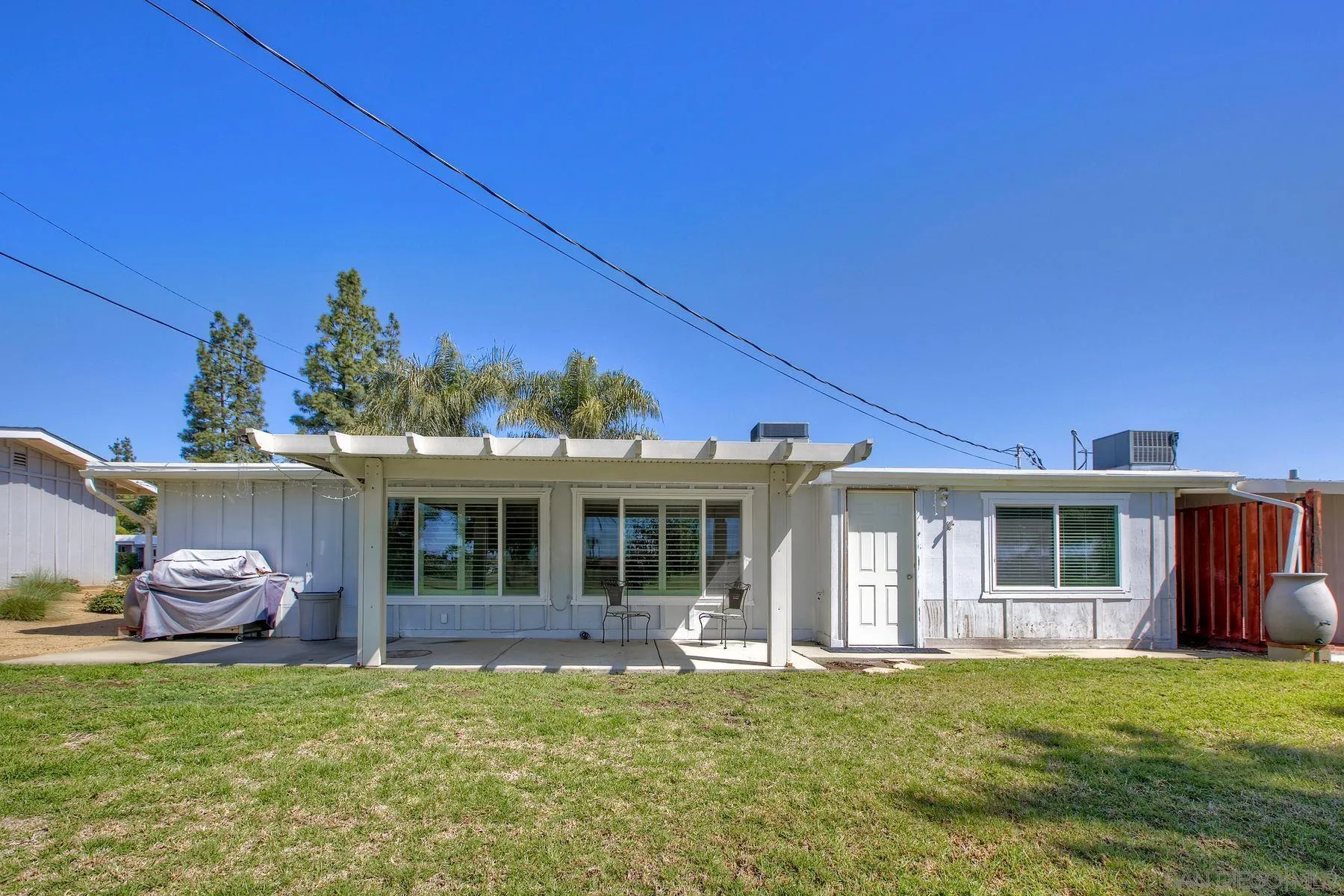 26055 Cherry Hills Boulevard Menifee, CA 92586 - Photo 29 of 31 a front view of a house with a garden