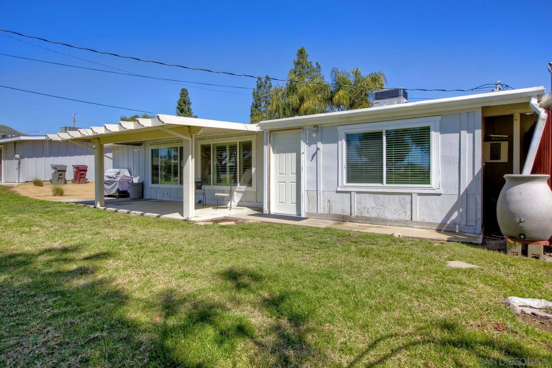 26055 Cherry Hills Boulevard Menifee, CA 92586 - Photo 30 of 31 a view of a house with backyard porch and sitting area