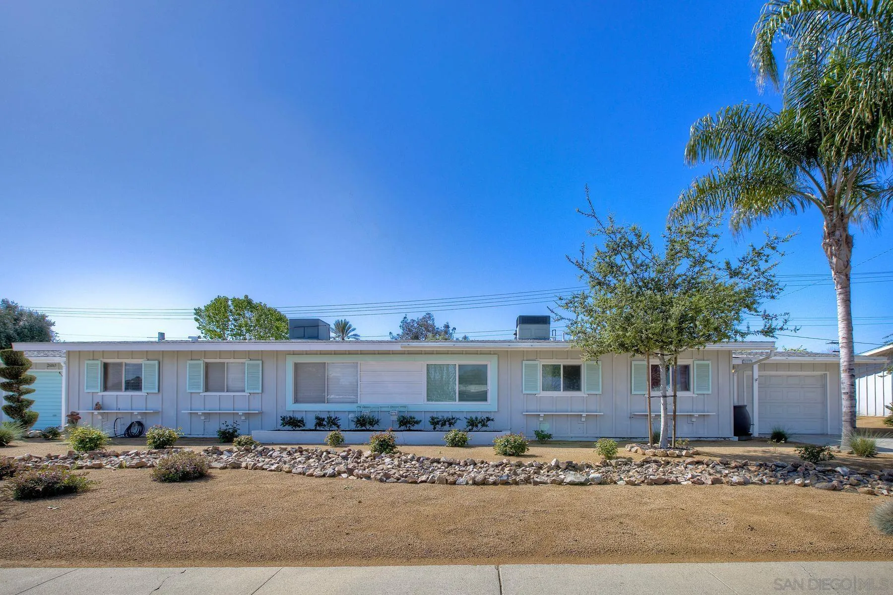 26055 Cherry Hills Boulevard Menifee, CA 92586 - Photo 4 of 31 a front view of a house with a yard
