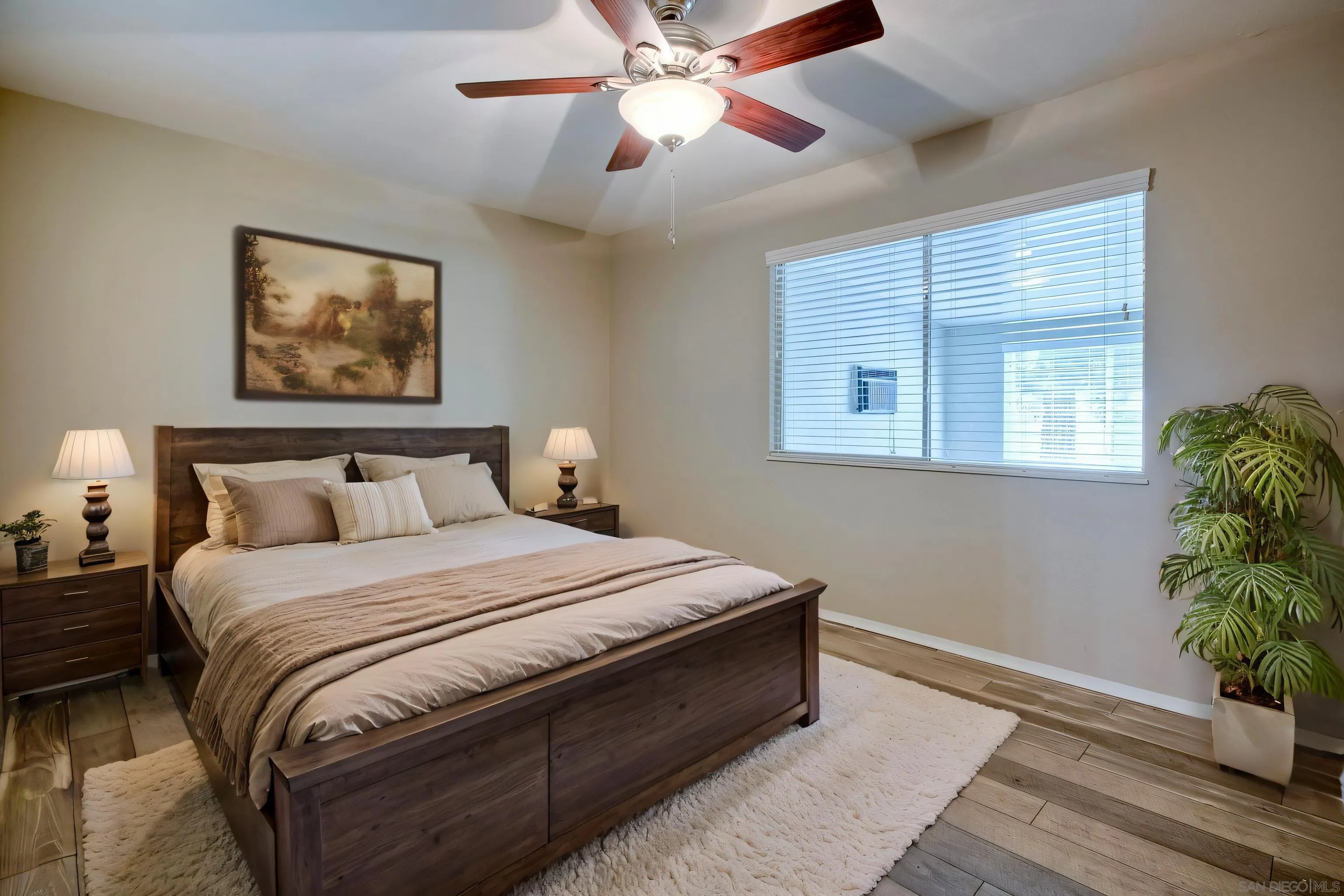 26055 Cherry Hills Boulevard Menifee, CA 92586 - Photo 7 of 31 a bedroom with bed and a potted plant