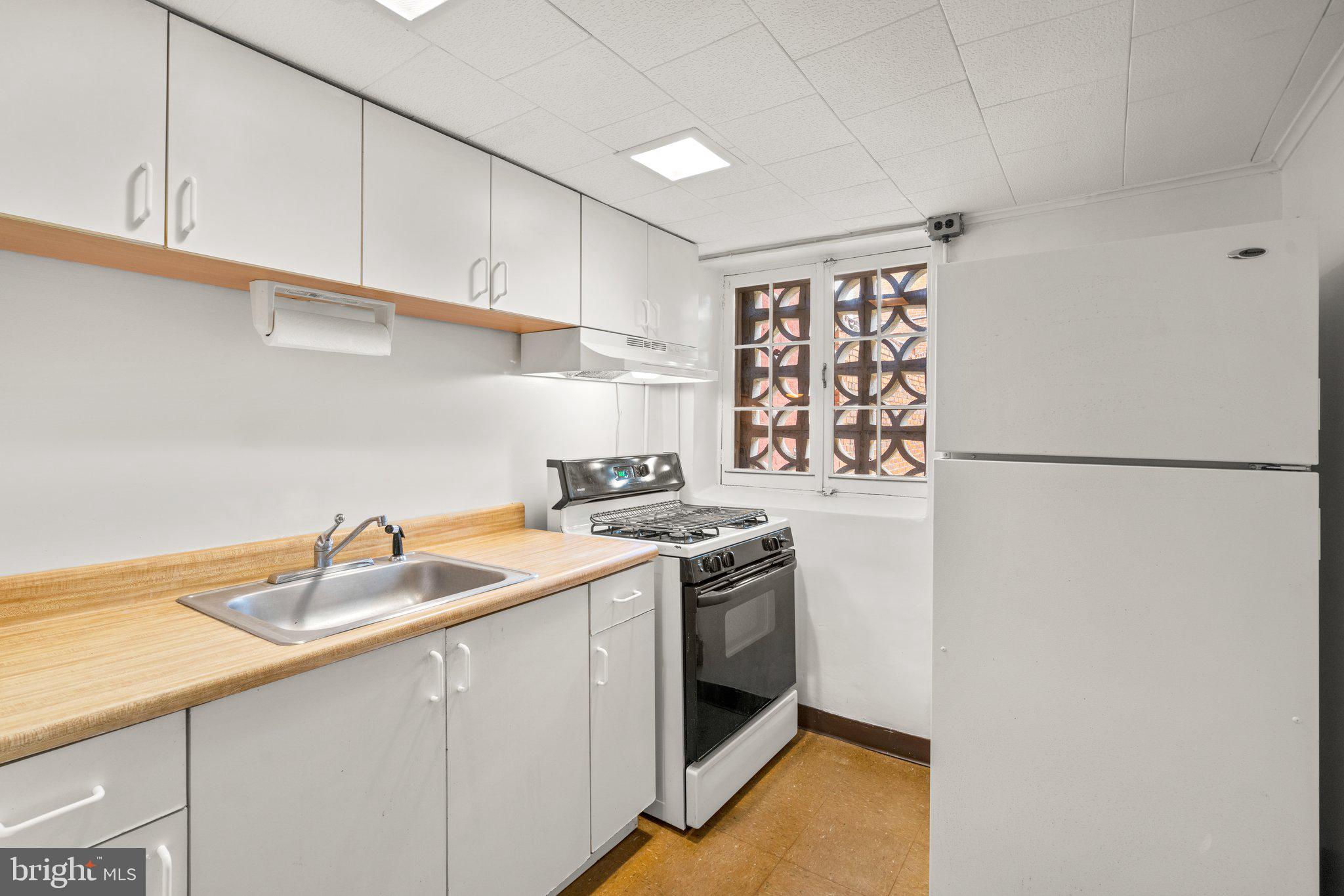 3703 Belair Road Baltimore, MD 21213 - Photo 21 of 30 Second lower-level full kitchen, white cabinets