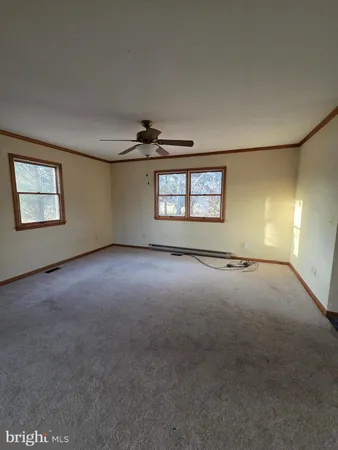 an empty room with windows and entrance