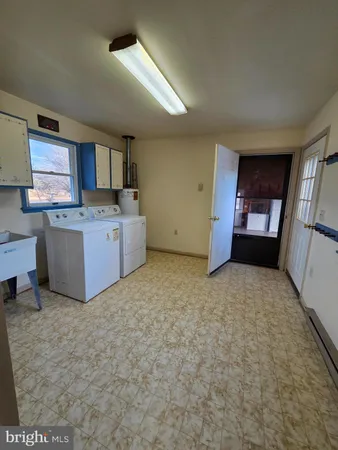 a view of a kitchen with furniture and a ceiling fan
