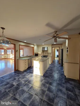 a kitchen with refrigerator and cabinets
