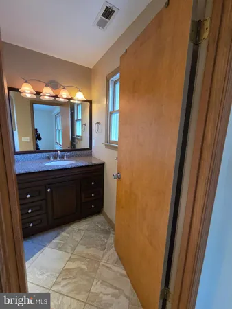 a spacious bathroom with a double vanity sink and a mirror