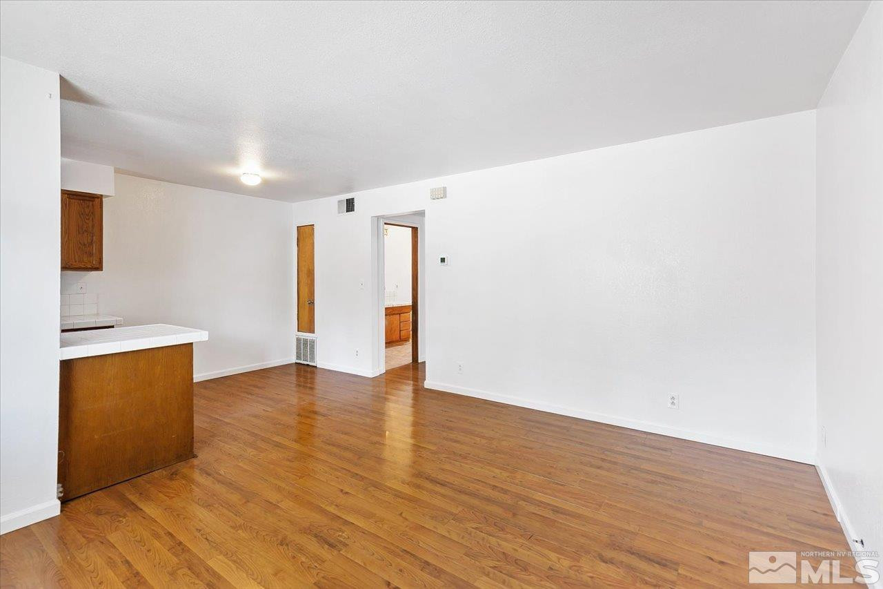 364 Wheeler Avenue Reno, NV 89502 - Photo 2 of 11 a view of an empty room with wooden floor