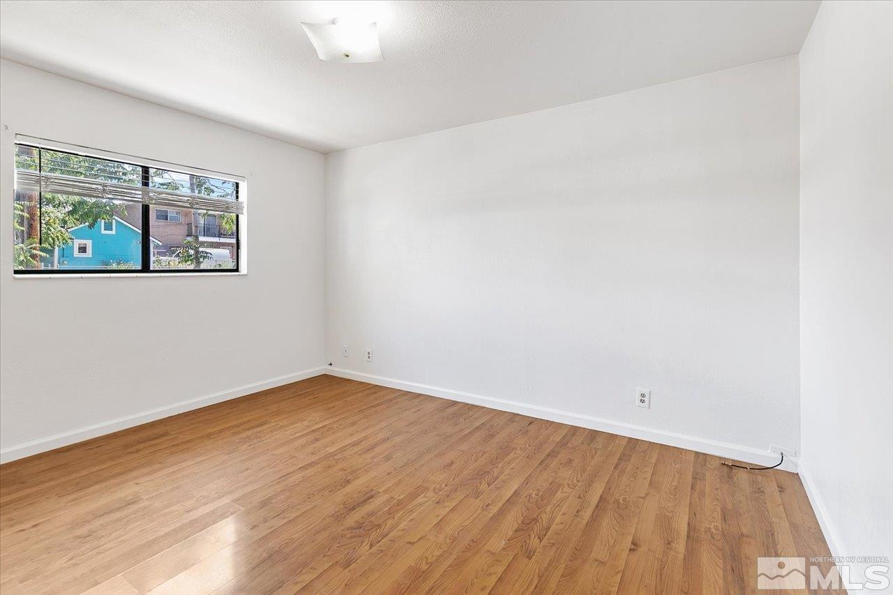 364 Wheeler Avenue Reno, NV 89502 - Photo 8 of 11 an empty room with wooden floor and window