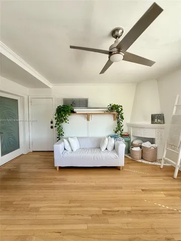 a living room with furniture and kitchen view