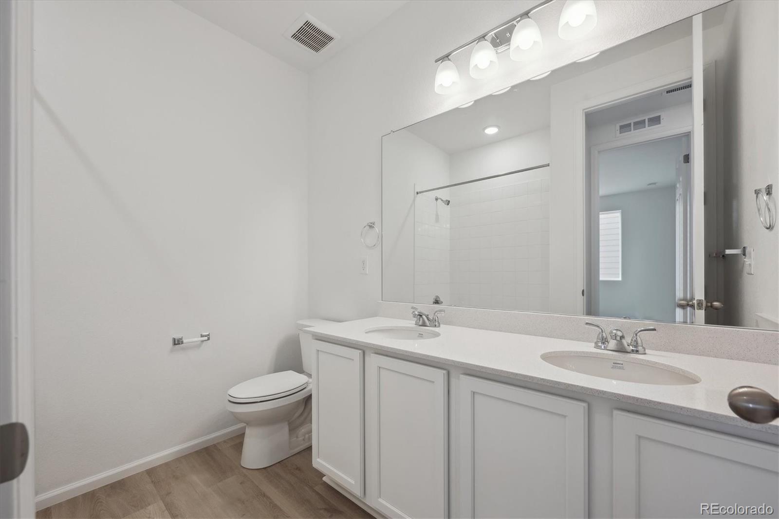 6122 Amerifax Drive Windsor, CO 80528 - Photo 16 of 21 a bathroom with a toilet sink and mirror