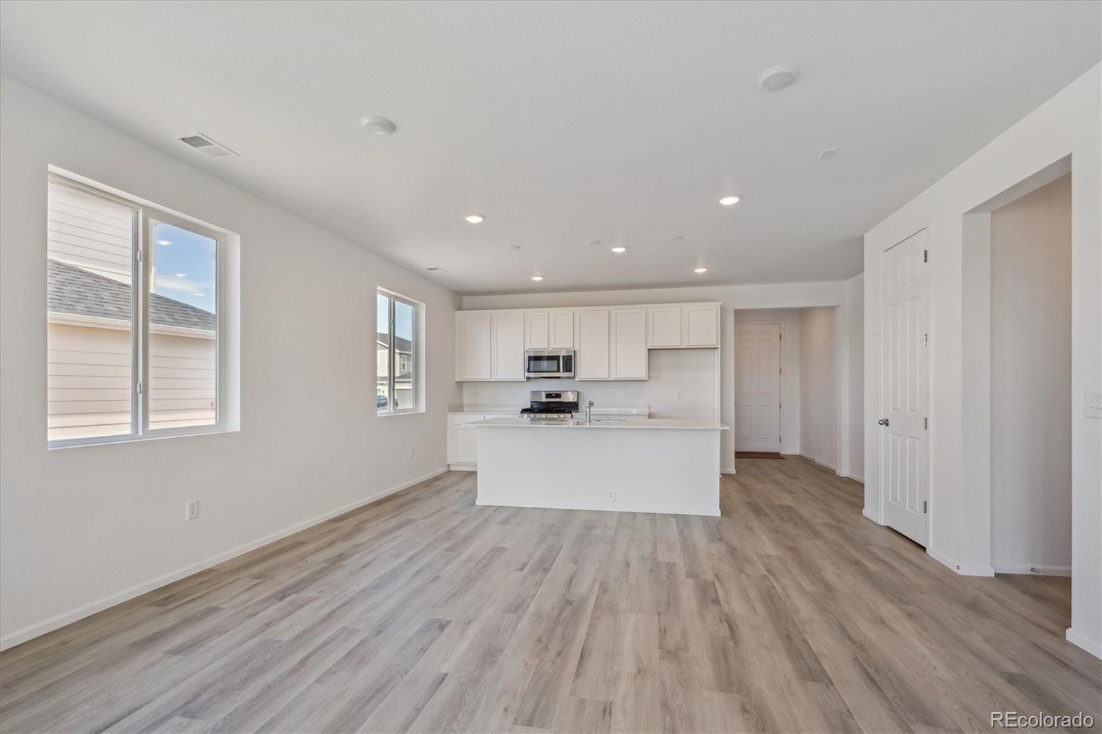 6122 Amerifax Drive Windsor, CO 80528 - Photo 5 of 21 a view of kitchen with refrigerator sink and wooden floor