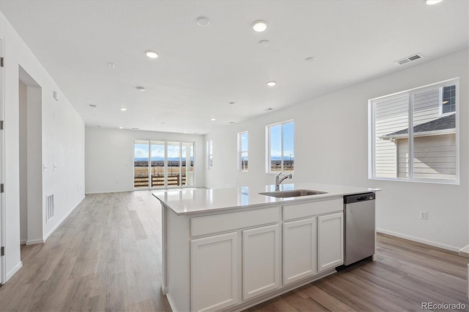 6122 Amerifax Drive Windsor, CO 80528 - Photo 6 of 21 a kitchen with center island wooden floor and a sink