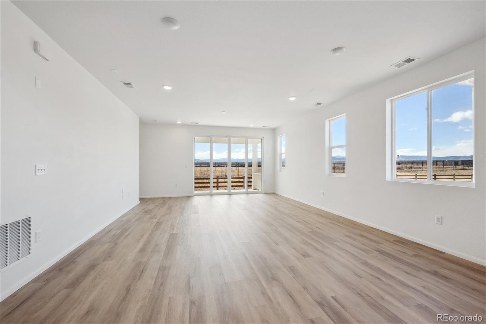 6122 Amerifax Drive Windsor, CO 80528 - Photo 7 of 21 a view of an empty room with wooden floor and a window