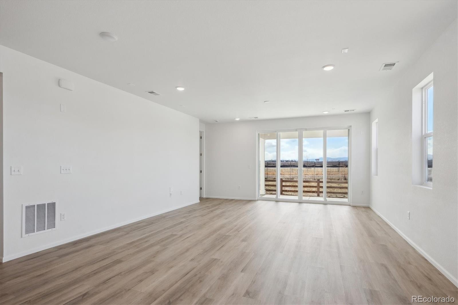 6122 Amerifax Drive Windsor, CO 80528 - Photo 8 of 21 wooden floor in an empty room with a window