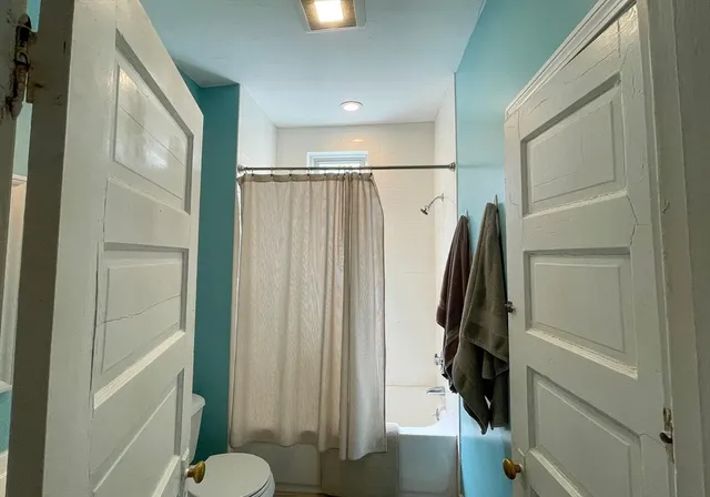 a bathroom with a shower and a toilet