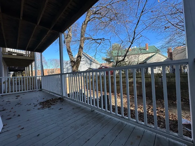 a view of a porch with wooden floor