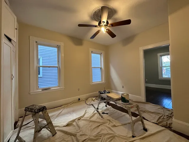 a bedroom with a bed and ceiling fan