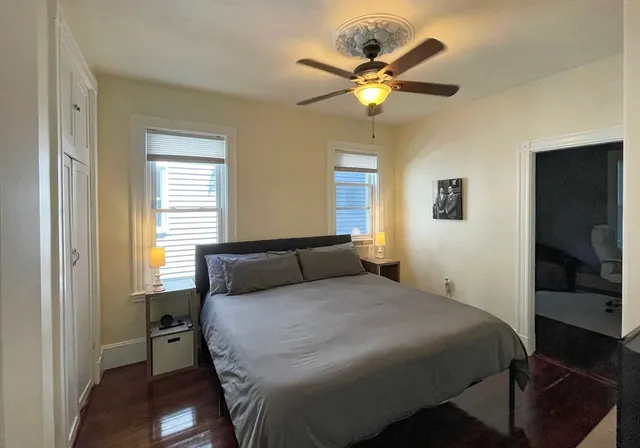 a bedroom with a bed and a chandelier