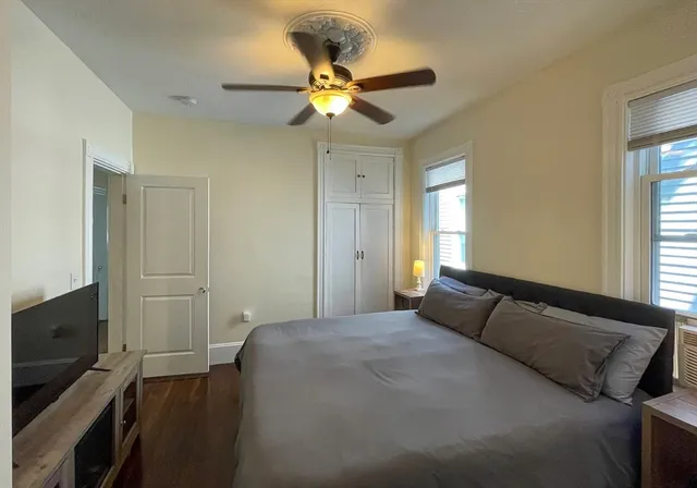 a bedroom with a bed and a ceiling fan