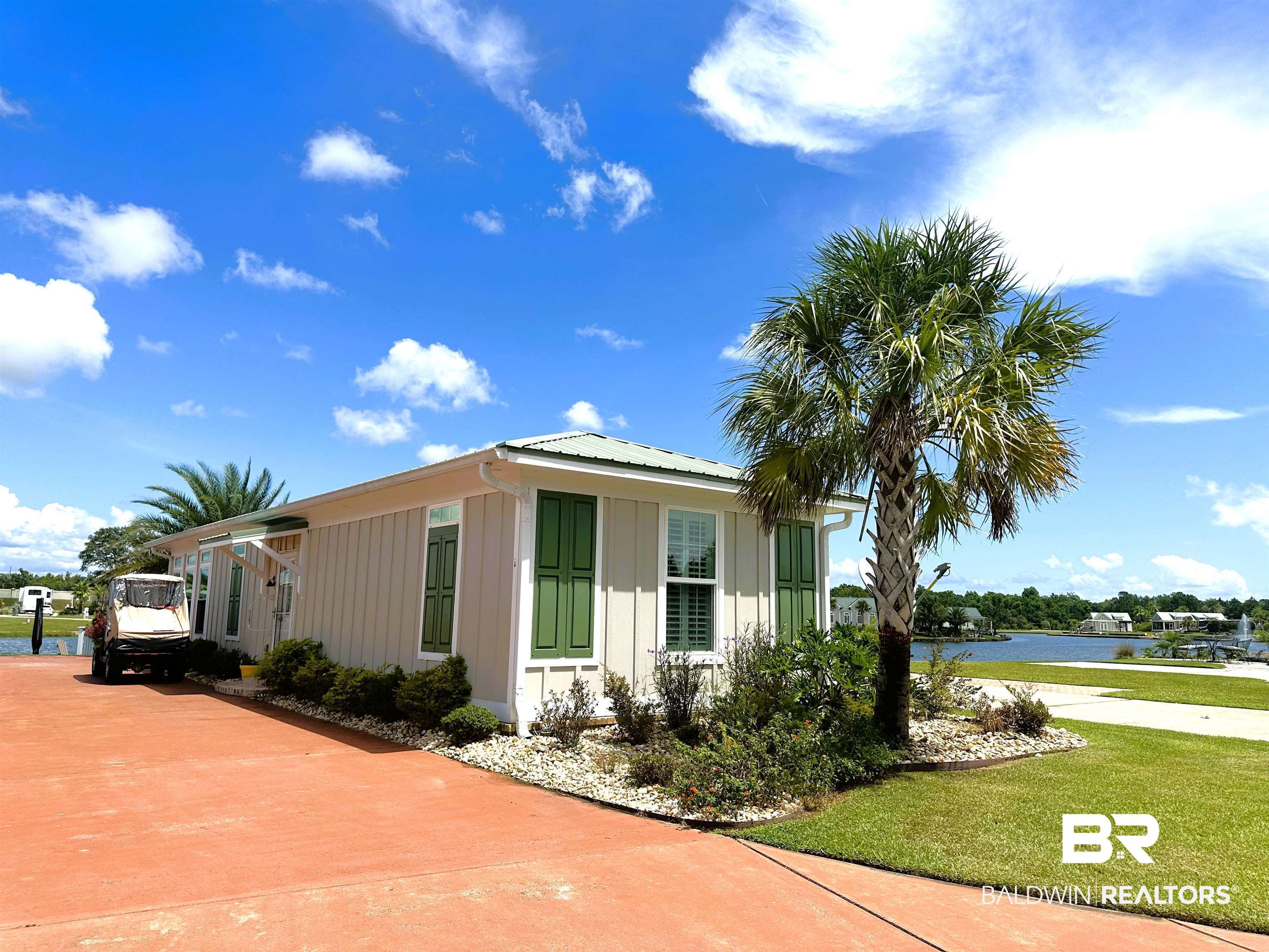 View of front of property with a water view and a front lawn
