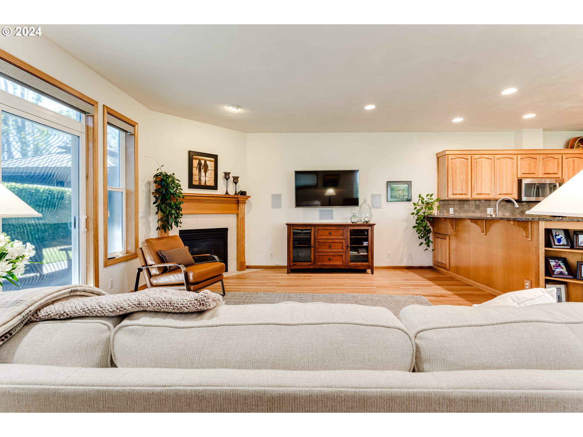 999 Old Orchard Lane Springfield, OR 97477 - Photo 4 of 34 a living room with furniture a fireplace and a flat screen tv