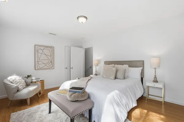 a bedroom with a bed and a couch