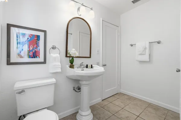 a bathroom with a sink mirror and toilet
