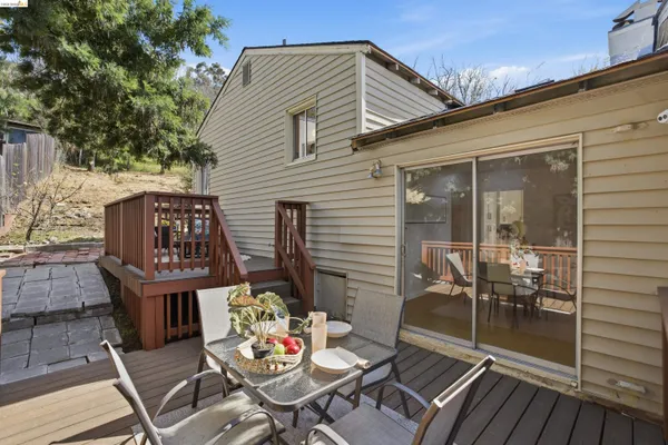 a view of a patio with table and chairs and potted plants
