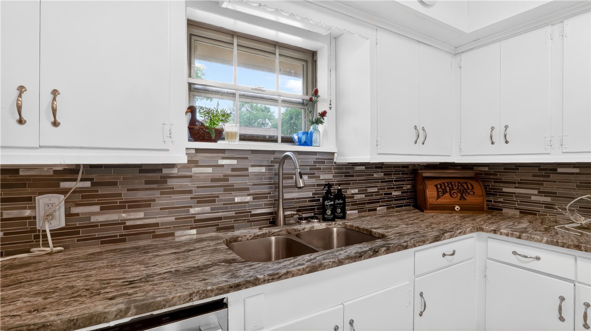 405 North Main Street Franklin, TX 77856 - Photo 14 of 28 a kitchen with granite countertop white cabinets and a sink
