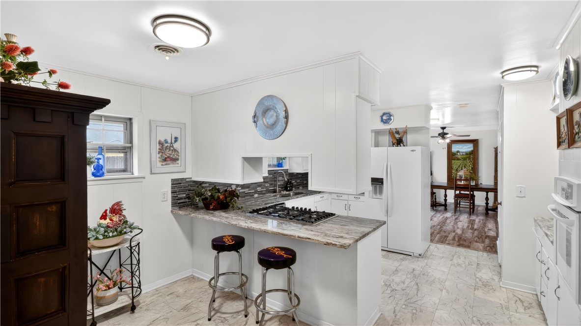 405 North Main Street Franklin, TX 77856 - Photo 16 of 28 a kitchen with stainless steel appliances granite countertop a stove and a dining table