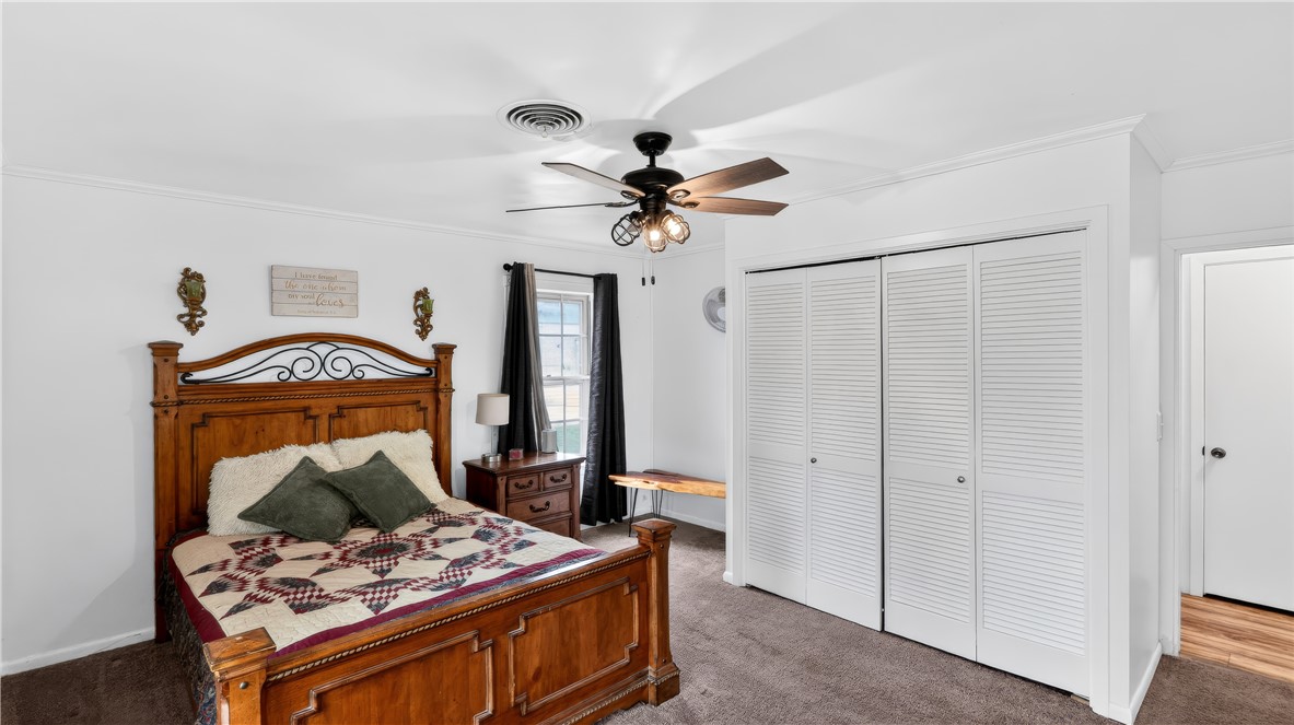 405 North Main Street Franklin, TX 77856 - Photo 23 of 28 a bedroom with a bed and a chandelier