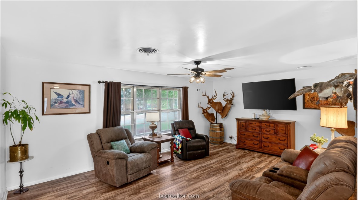405 North Main Street Franklin, TX 77856 - Photo 6 of 28 a living room with furniture a flat screen tv and a fireplace