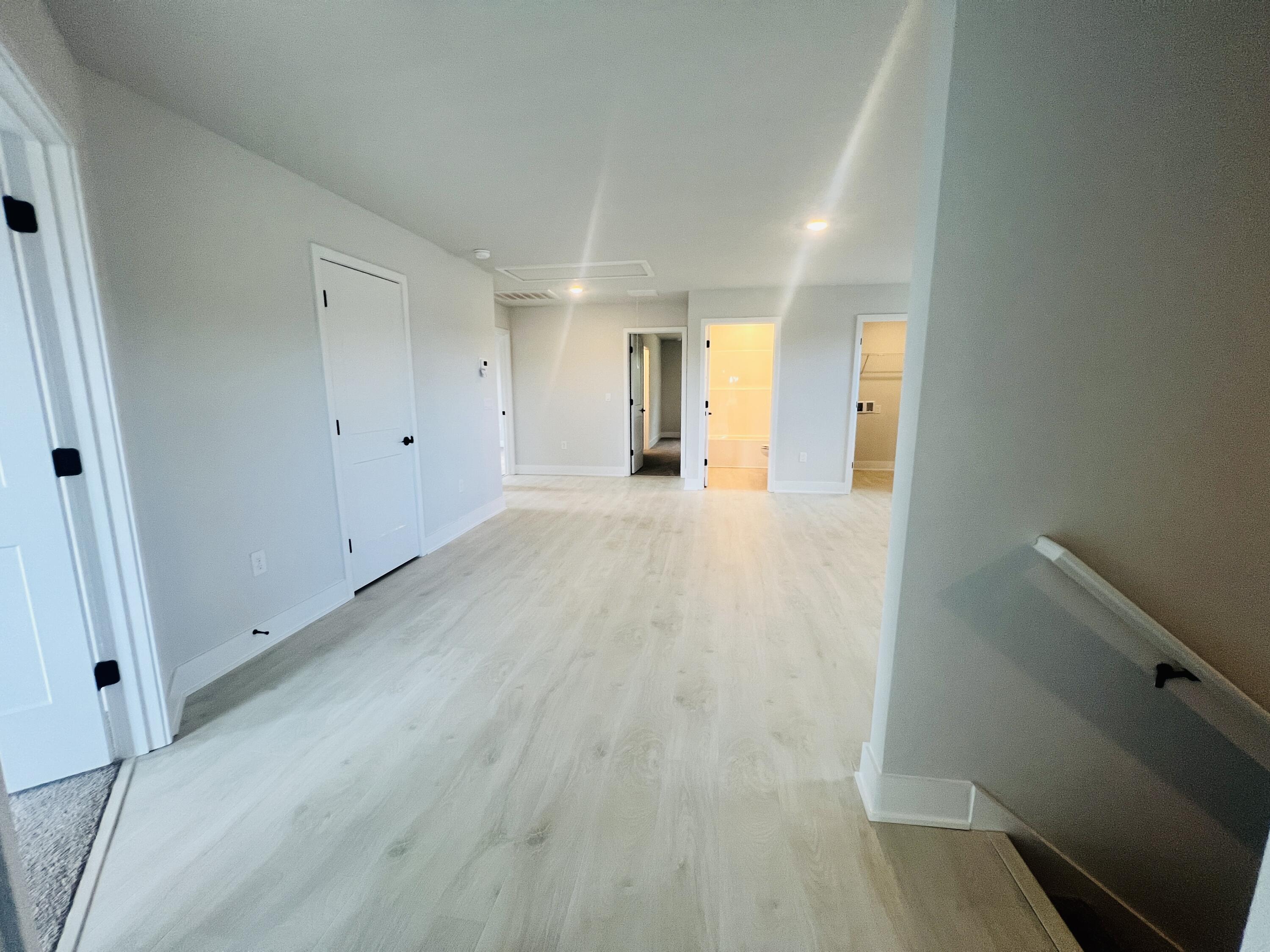 5291 Hidden Pines Circle Milton, FL 32583 - Photo 12 of 21 a view of a big room with wooden floor and windows