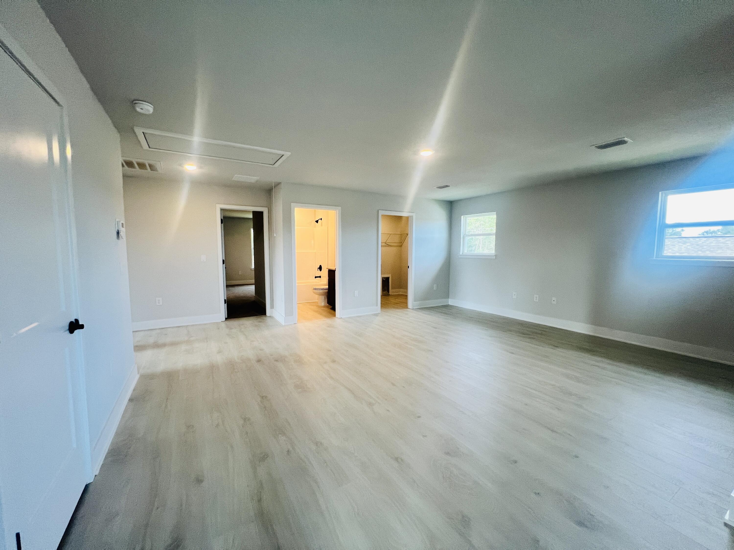 5291 Hidden Pines Circle Milton, FL 32583 - Photo 13 of 21 an empty room with wooden floor and windows