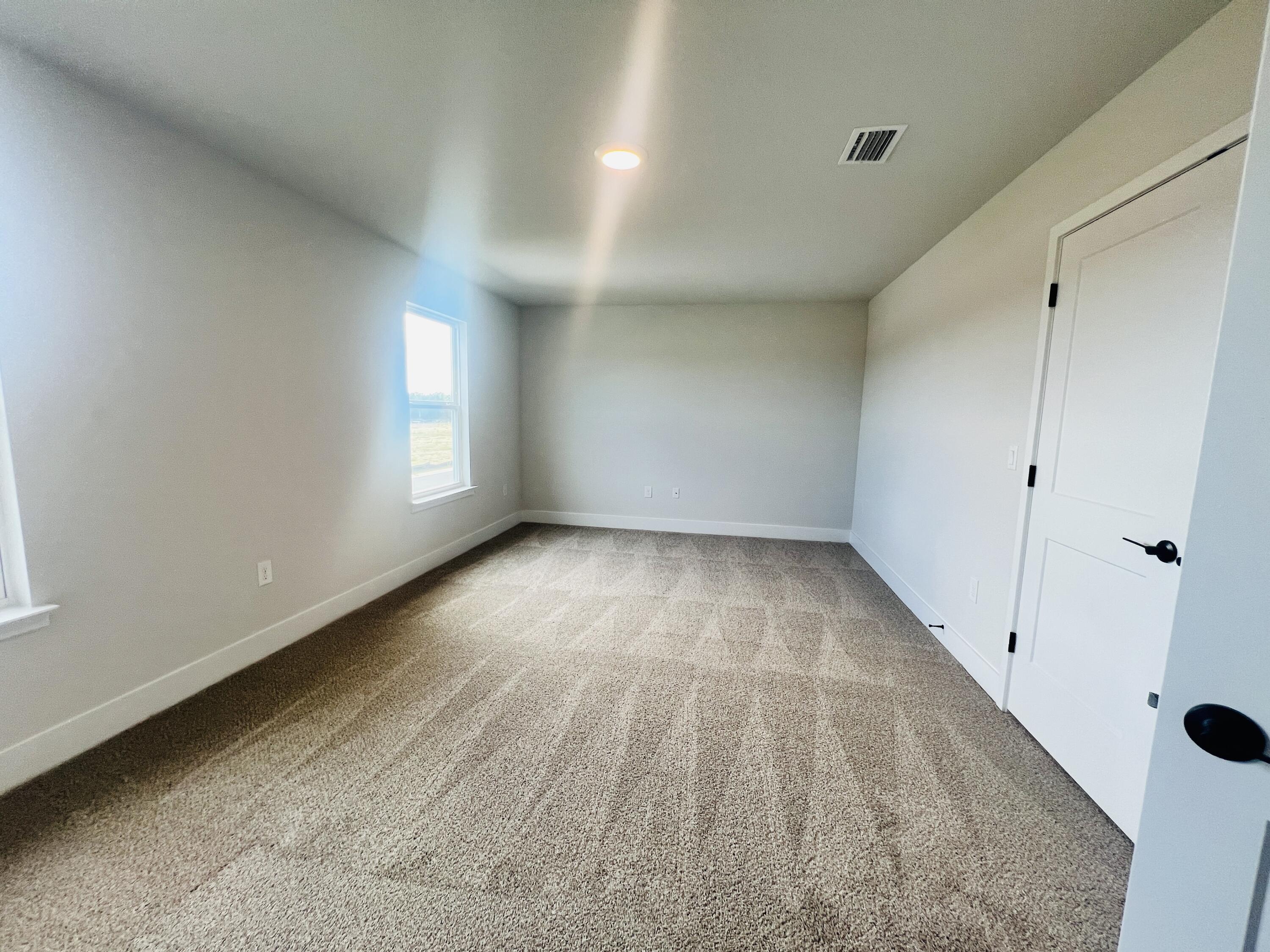 5291 Hidden Pines Circle Milton, FL 32583 - Photo 14 of 21 wooden floor in an empty room with a window