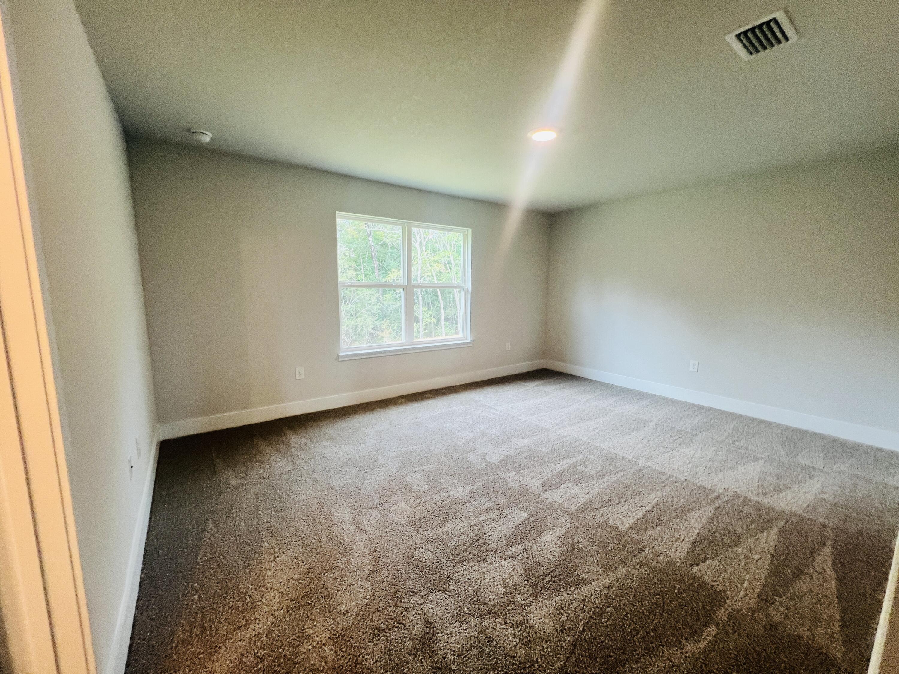 5291 Hidden Pines Circle Milton, FL 32583 - Photo 17 of 21 an empty room with windows
