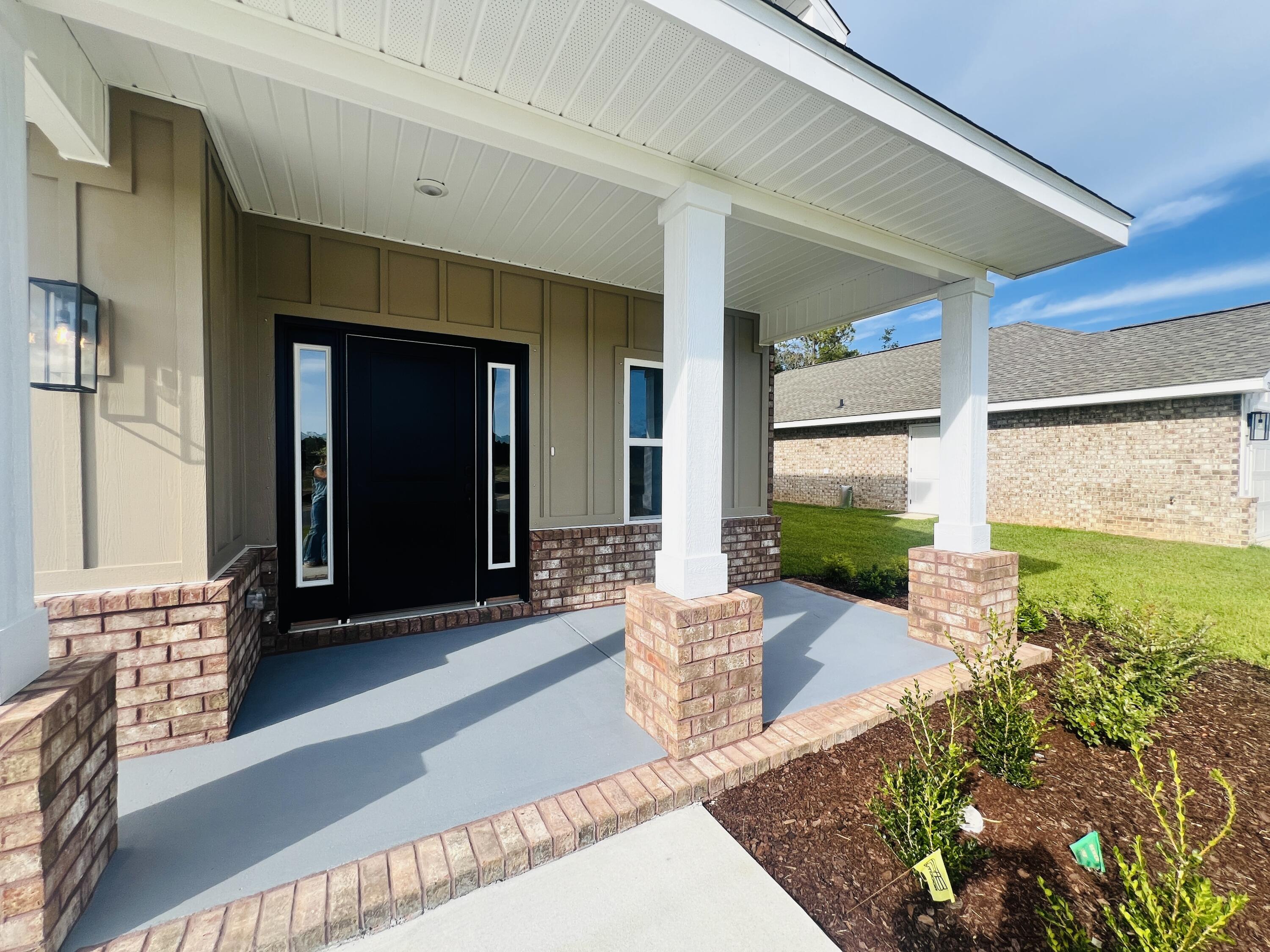 5291 Hidden Pines Circle Milton, FL 32583 - Photo 4 of 21 a front view of a house with garden